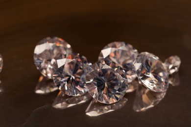 Photo of Beautiful shiny gemstones on golden tray, closeup