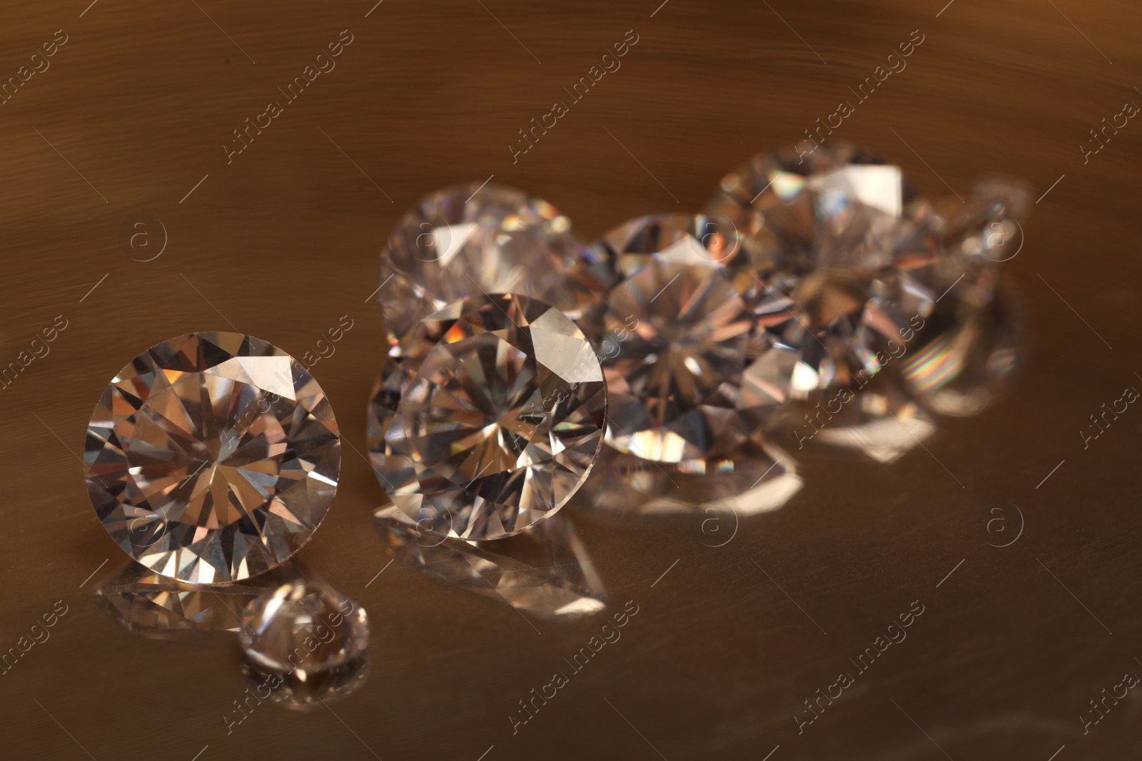 Photo of Beautiful shiny gemstones on golden tray, closeup