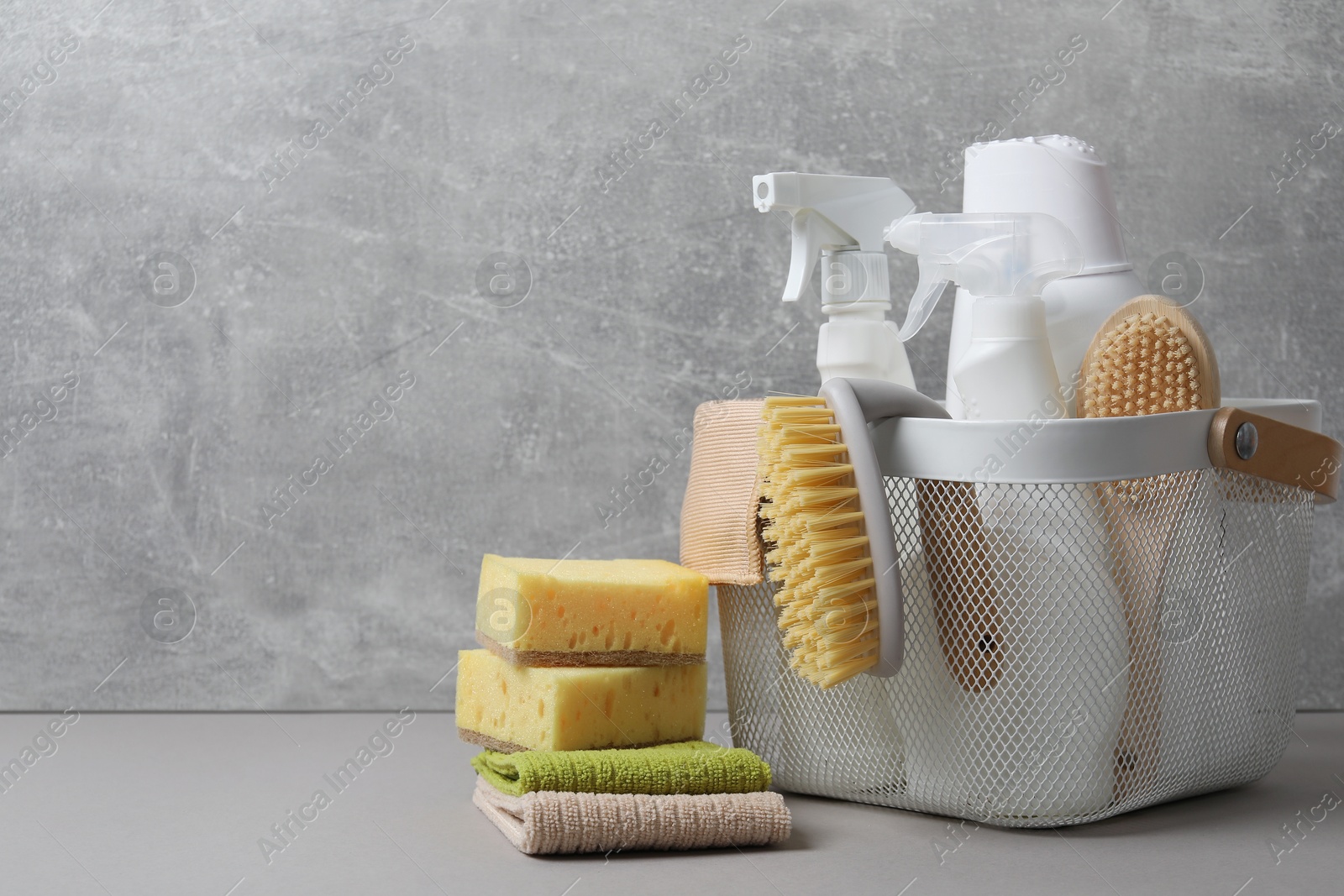 Photo of Eco-friendly cleaning products and supplies on grey table, space for text