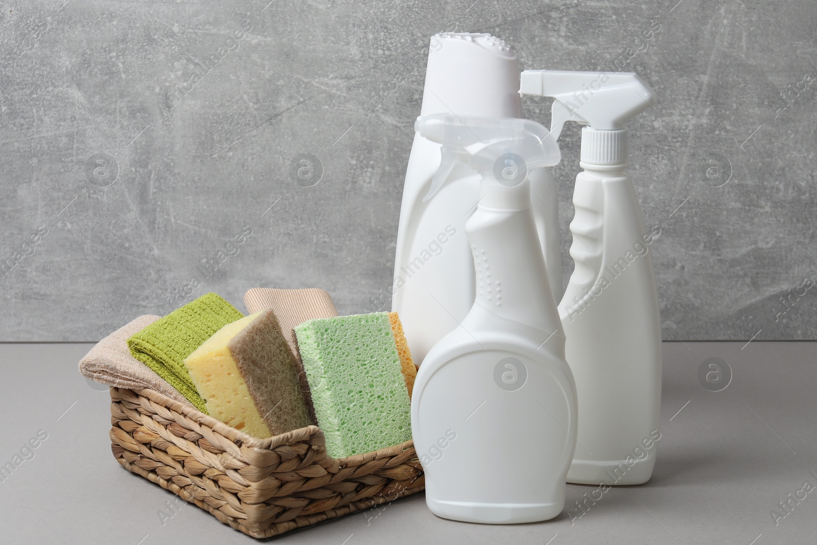 Photo of Eco-friendly cleaning products and supplies on grey table