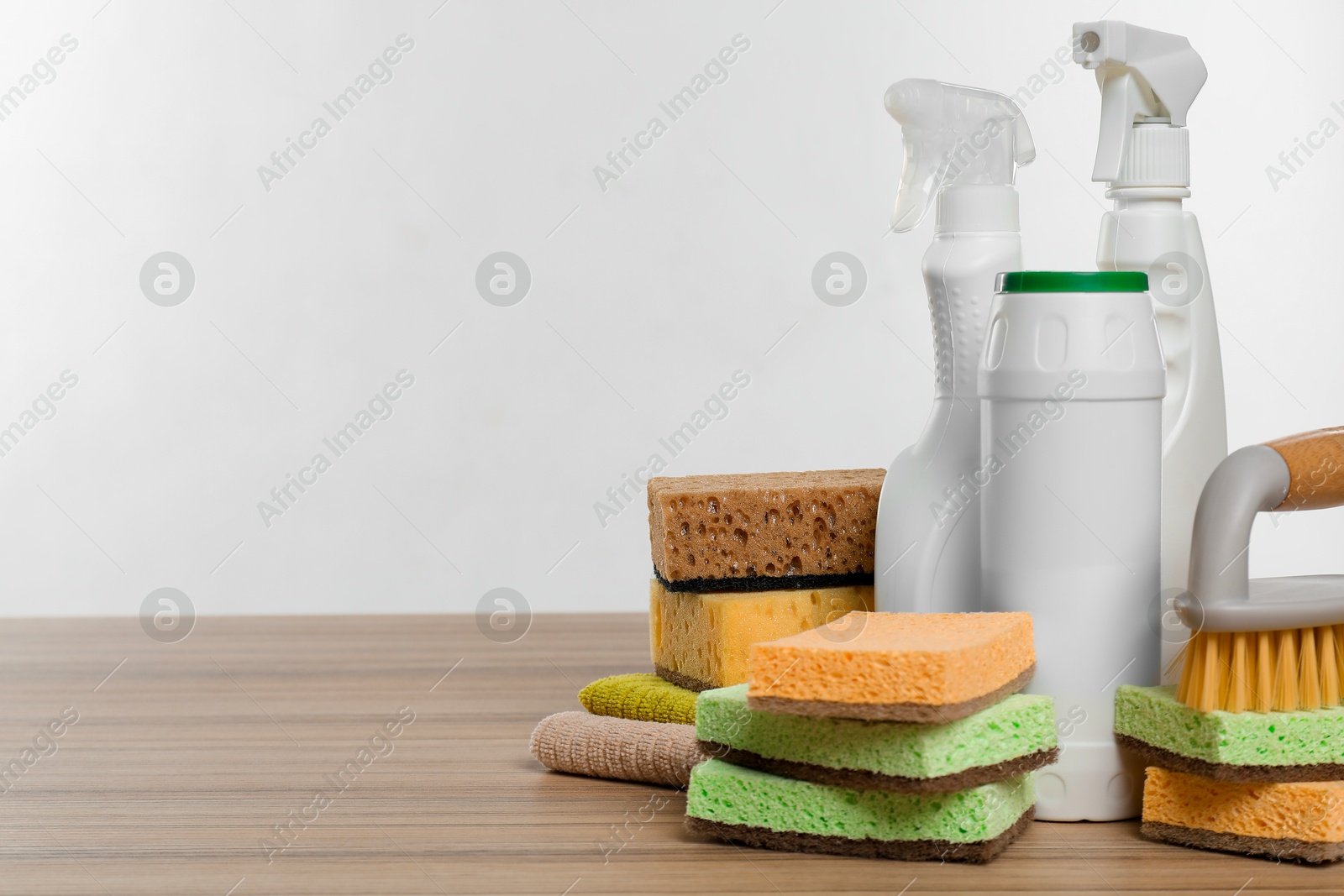 Photo of Eco-friendly cleaning products and supplies on wooden table, space for text