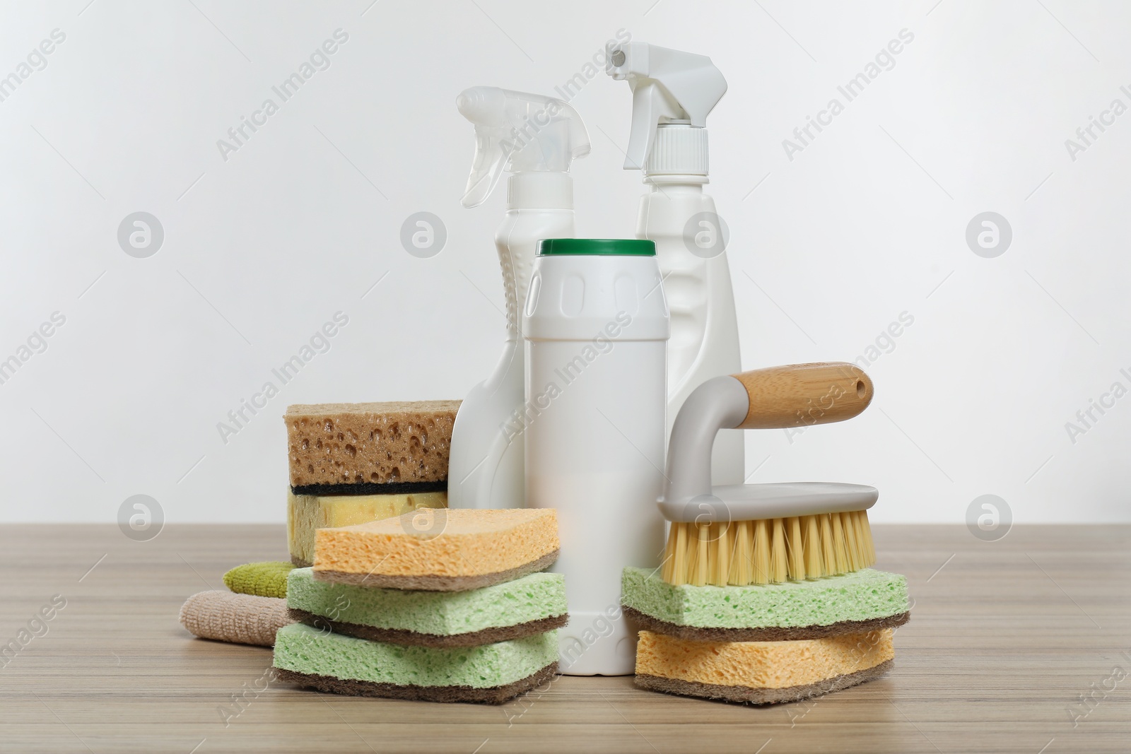 Photo of Eco-friendly cleaning products and supplies on wooden table