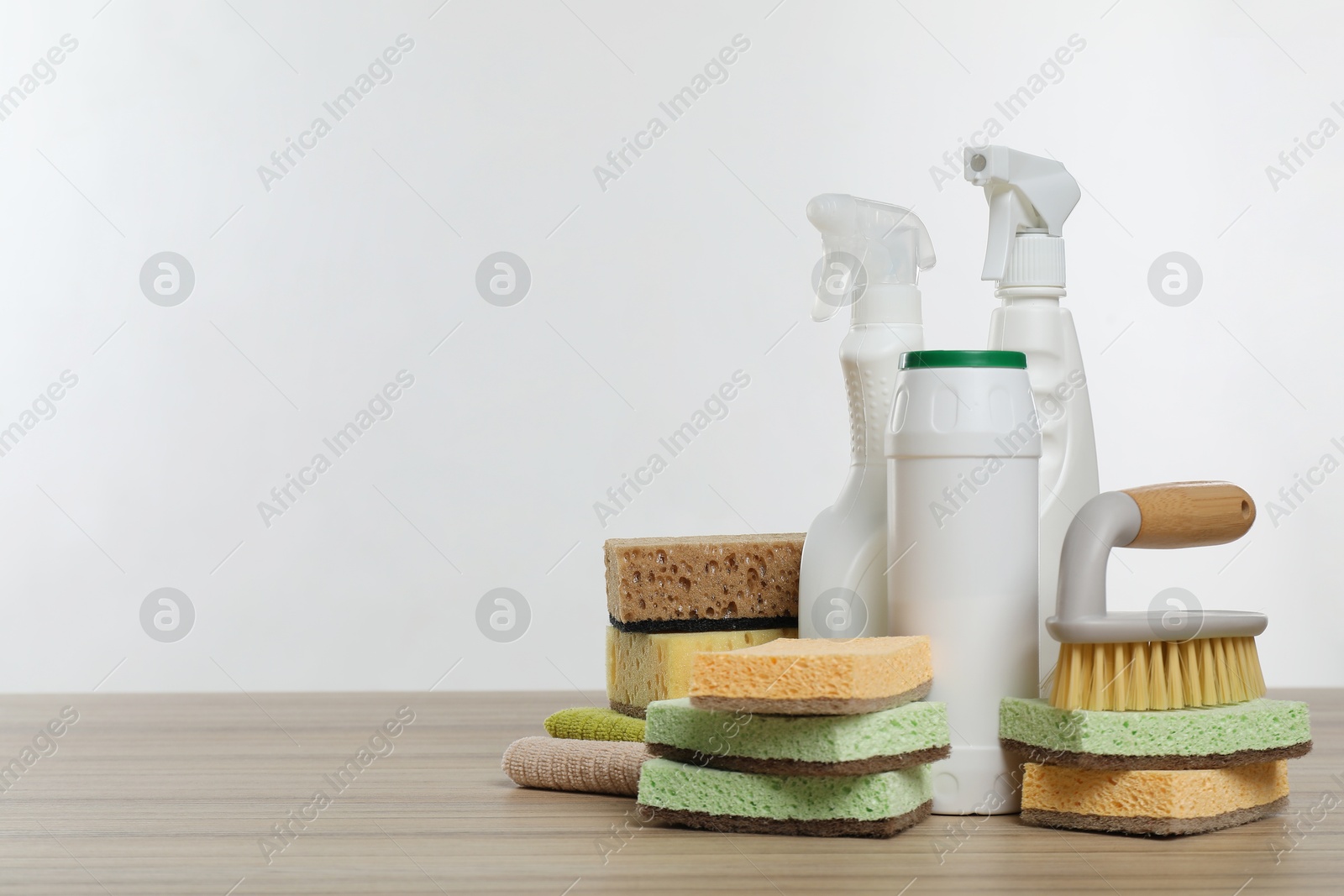 Photo of Eco-friendly cleaning products and supplies on wooden table, space for text