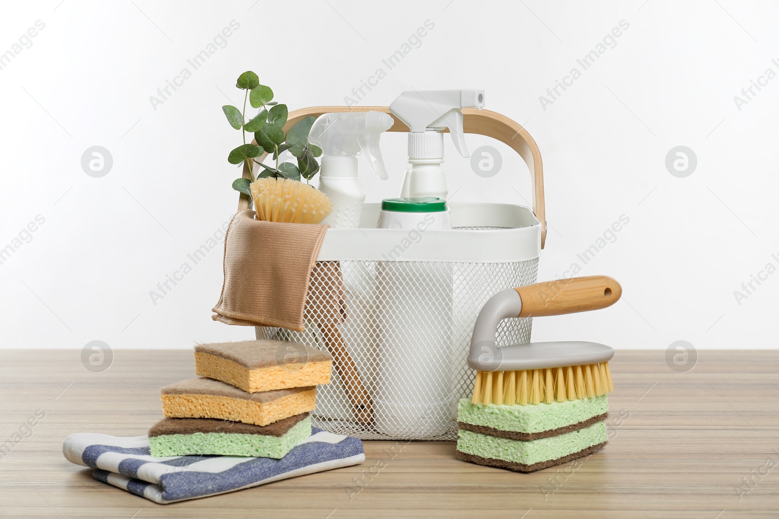 Photo of Eco-friendly cleaning products, supplies and eucalyptus branches on wooden table