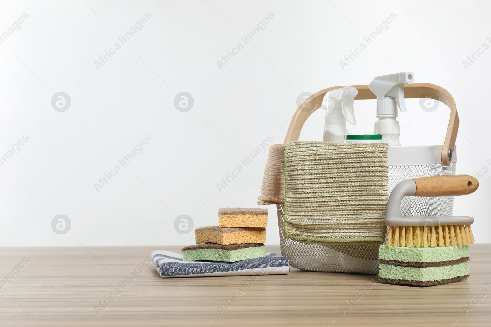 Photo of Eco-friendly cleaning products and supplies on wooden table, space for text