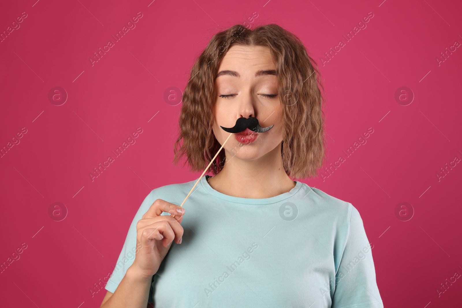 Photo of Funny woman with fake paper mustache on pink background