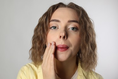 Photo of Beautiful woman after mustache removal procedure on grey background