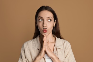 Photo of Funny woman with drawn mustache on brown background