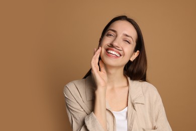 Photo of Happy woman with drawn mustache on brown background. Space for text