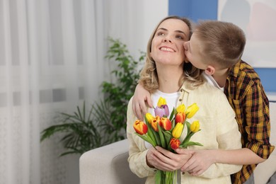 Photo of Happy Mother's Day. Son greeting his mom with flowers at home. Space for text