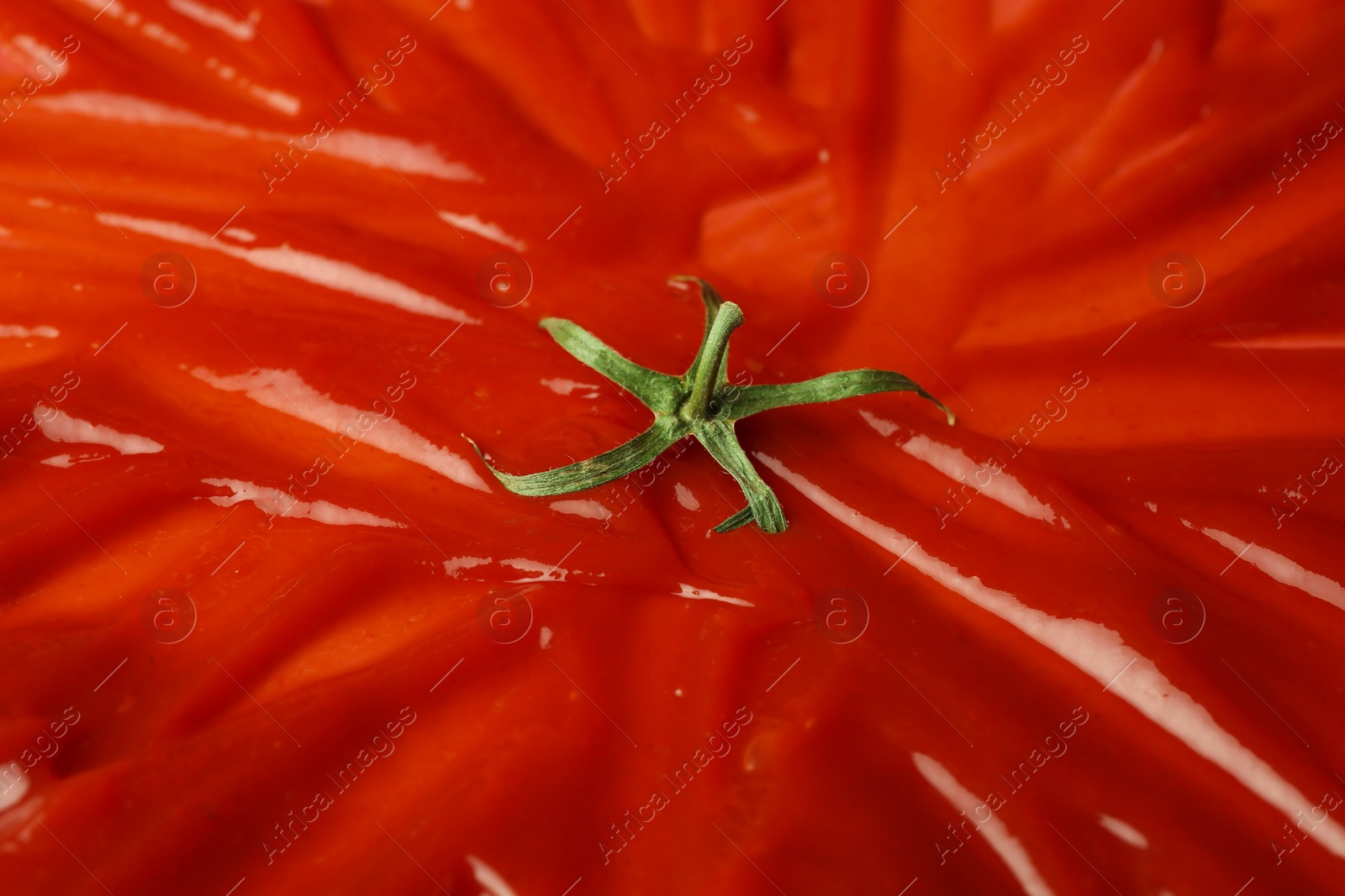 Photo of Slathered ketchup as smashed tomato, closeup view