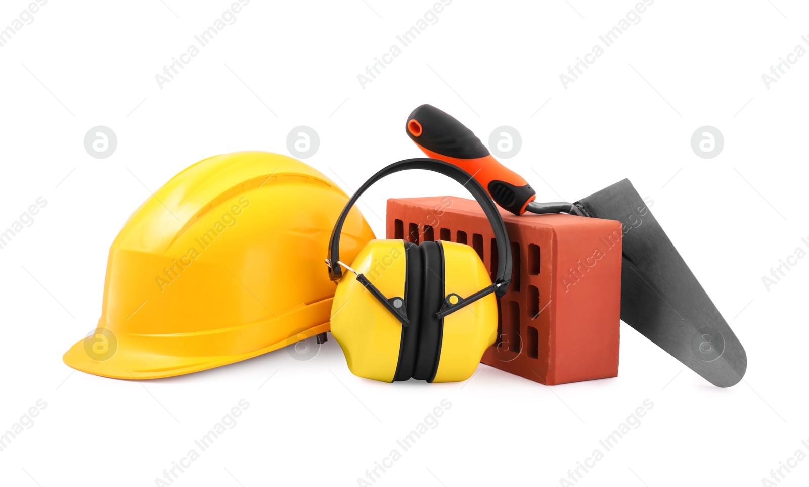 Photo of Protective equipment, brick and construction tool isolated on white