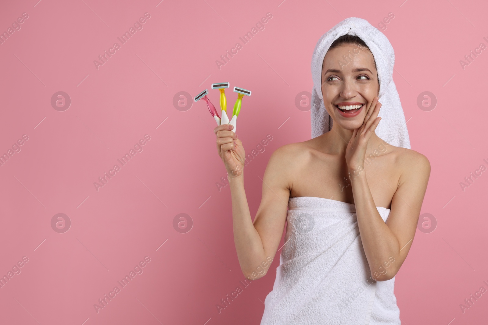 Photo of Happy woman with different razors on pink background, space for text. Hair removal tool