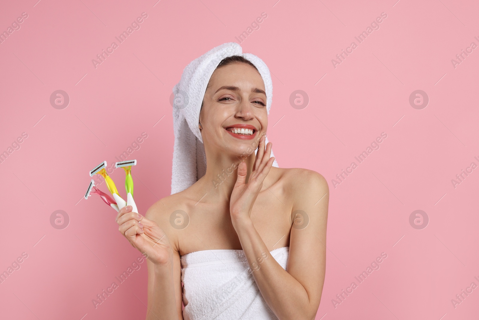 Photo of Happy woman with different razors on pink background. Hair removal tool