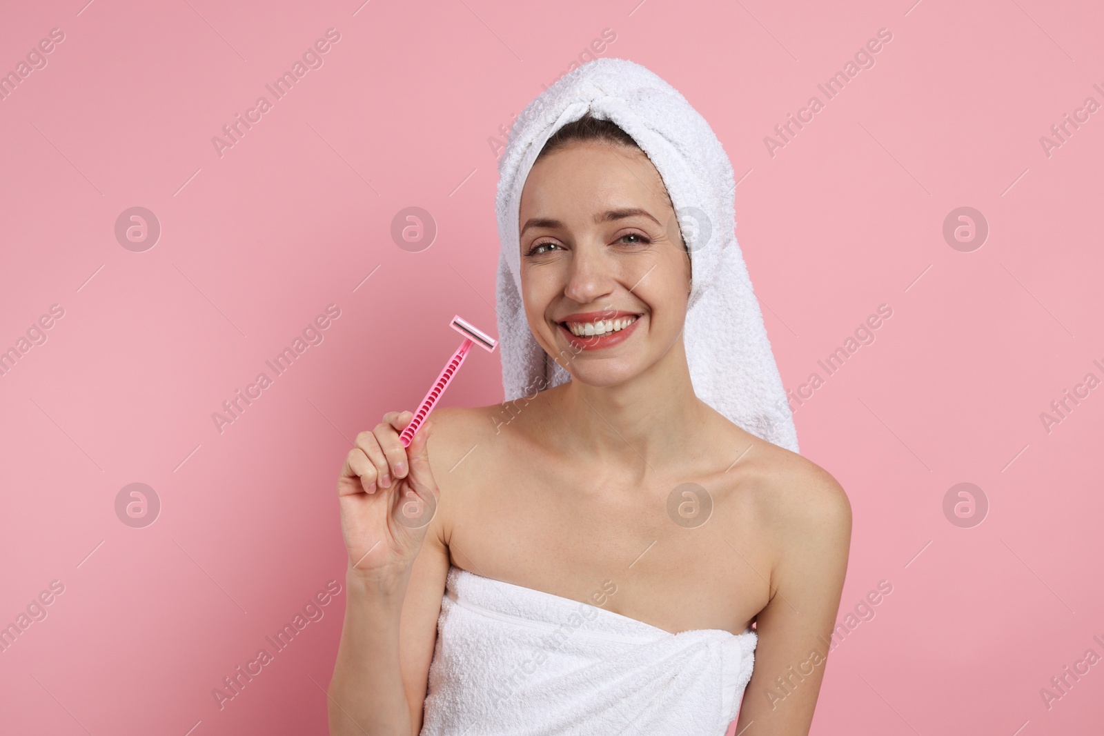 Photo of Happy woman with razor on pink background. Hair removal tool