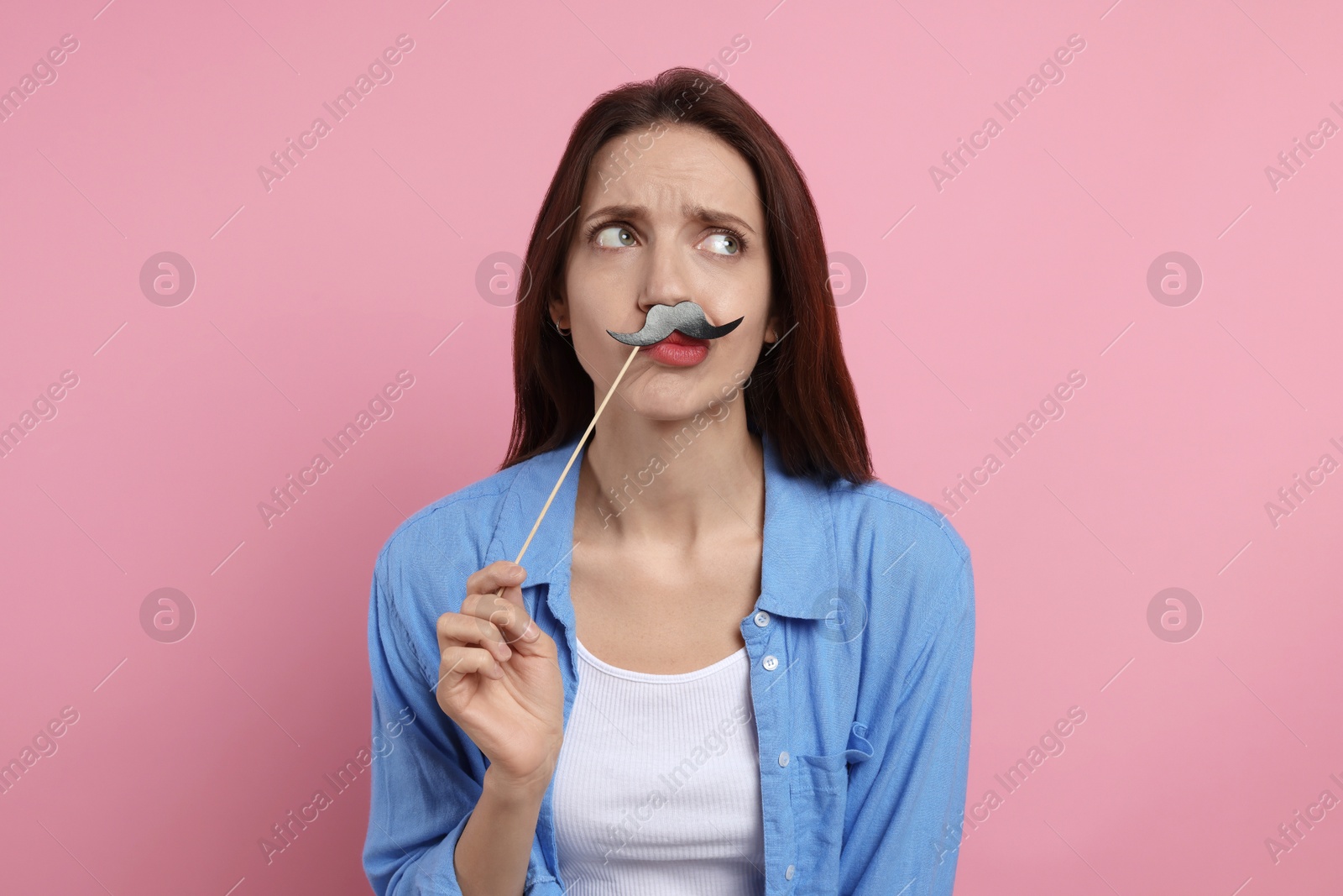 Photo of Woman with fake paper mustache on pink background