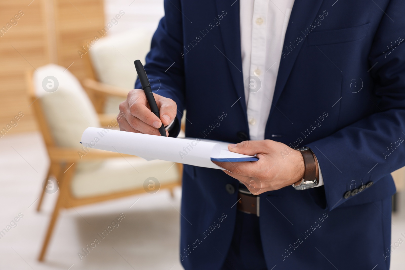 Photo of Real estate appraisal. Inspector with clipboard conducting property valuation at home, closeup