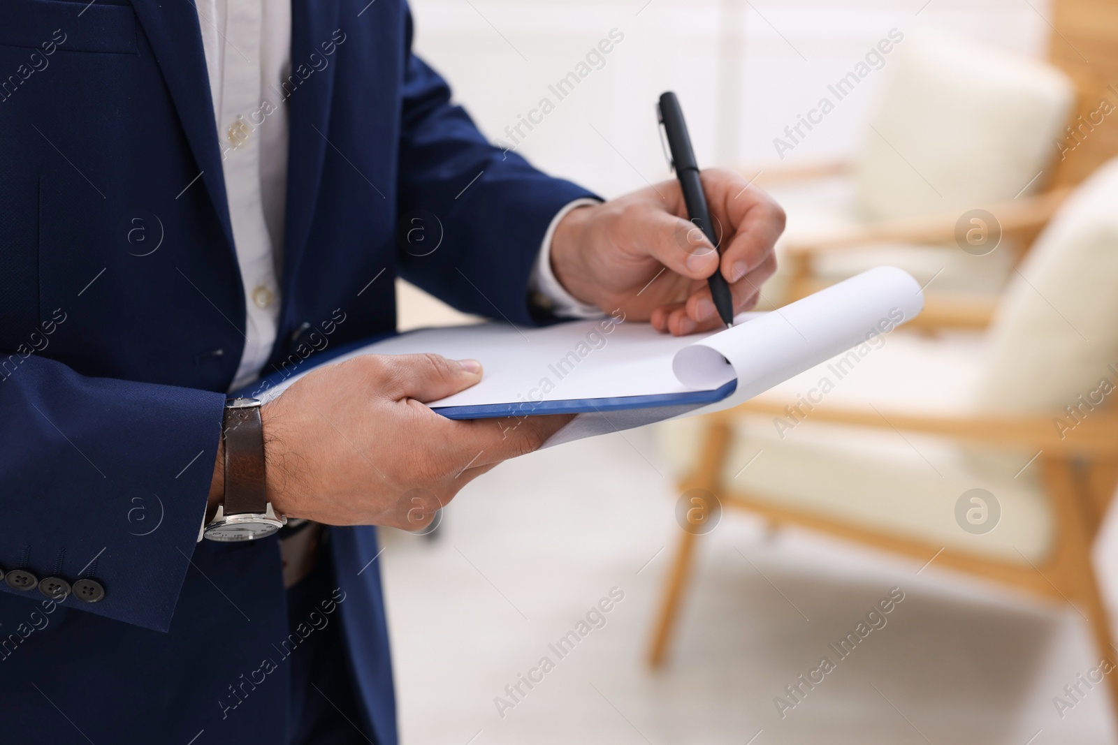 Photo of Real estate appraisal. Inspector with clipboard conducting property valuation at home, closeup