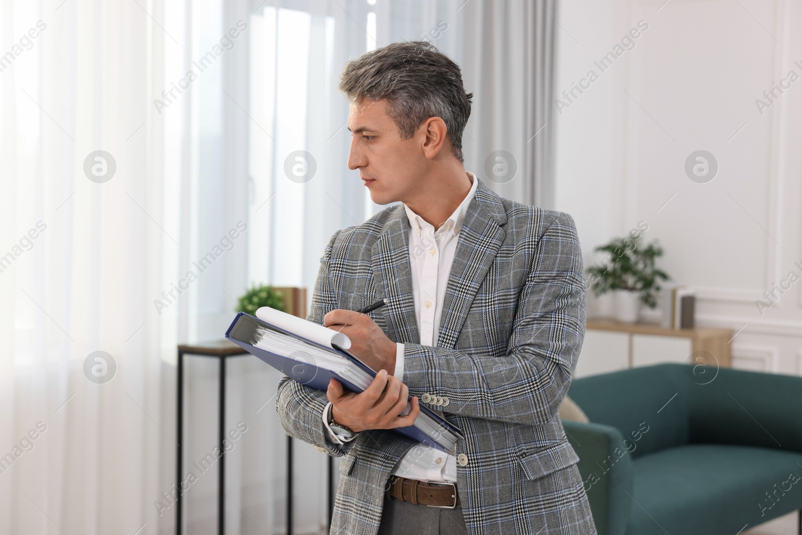 Photo of Real estate appraisal. Inspector with clipboard conducting property valuation at home