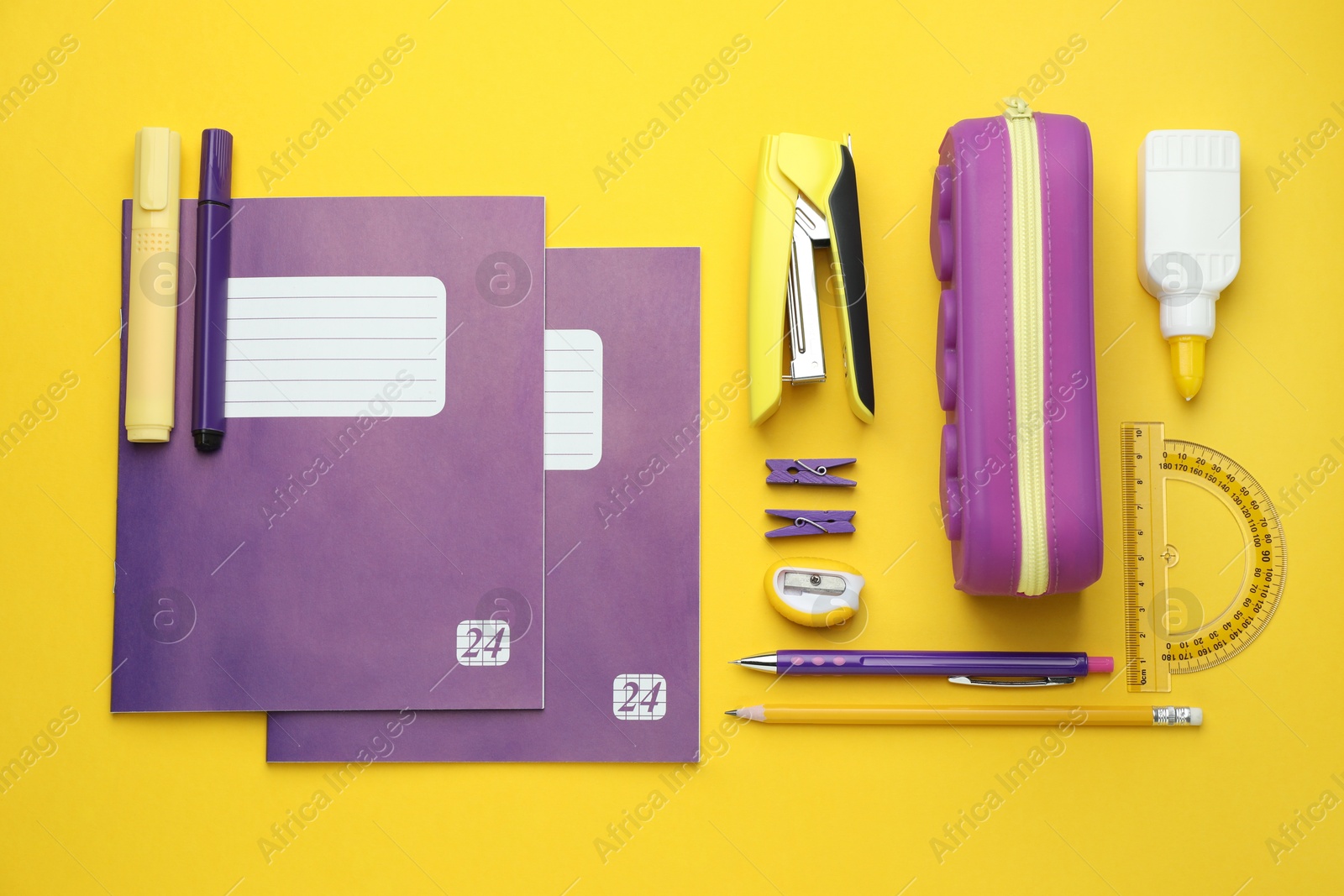 Photo of Copybooks and other school stationery on yellow background, flat lay