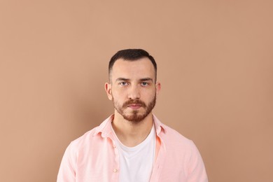 Photo of Baldness problem. Man with receding hairline on beige background