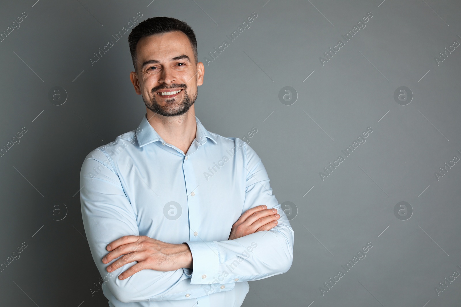 Photo of Portrait of handsome middle aged man on grey background, space for text