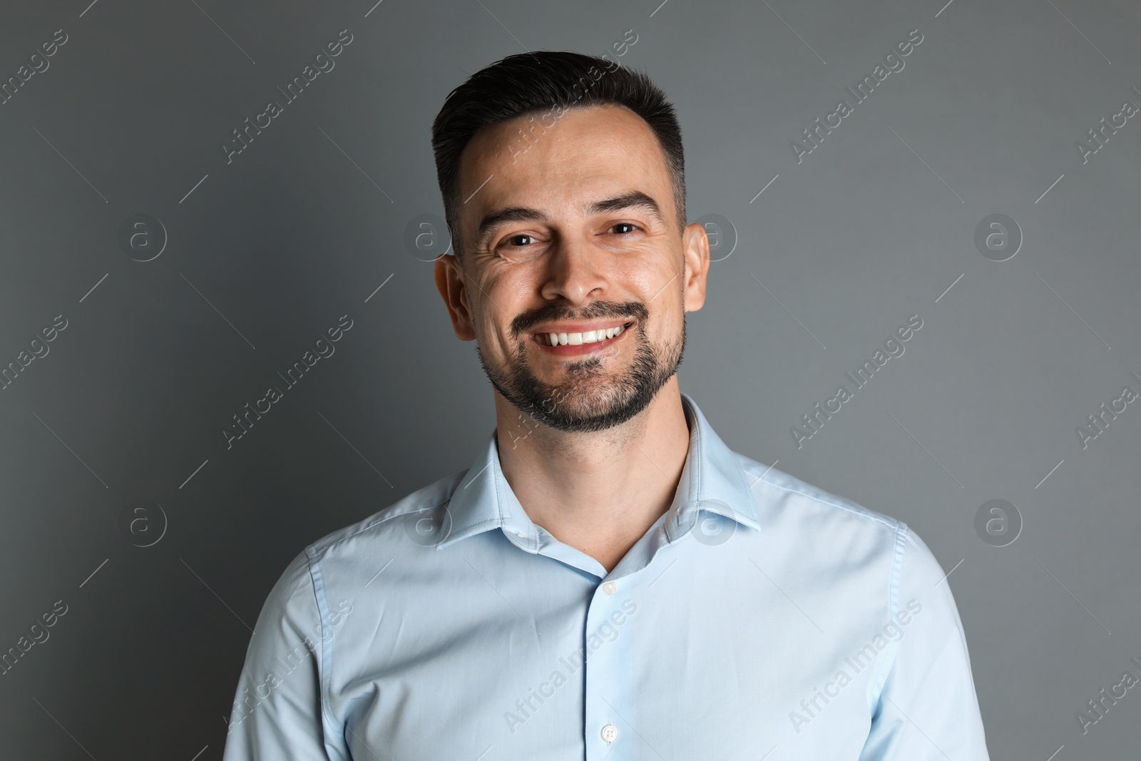 Photo of Portrait of handsome middle aged man on grey background