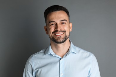 Photo of Portrait of handsome middle aged man on grey background