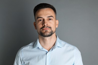 Photo of Portrait of handsome middle aged man on grey background