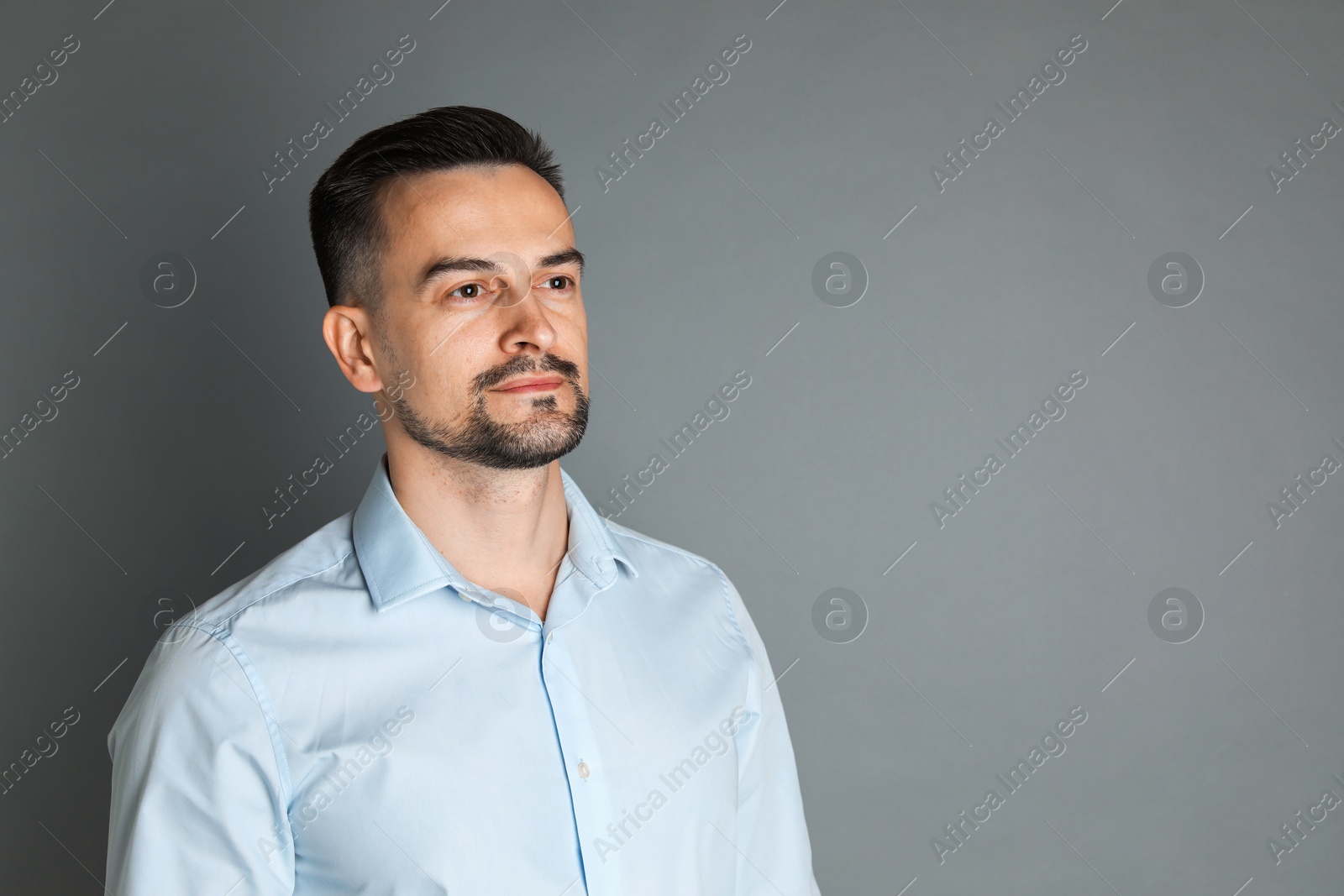 Photo of Portrait of handsome middle aged man on grey background, space for text