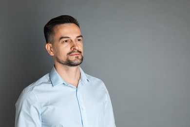 Photo of Portrait of handsome middle aged man on grey background, space for text