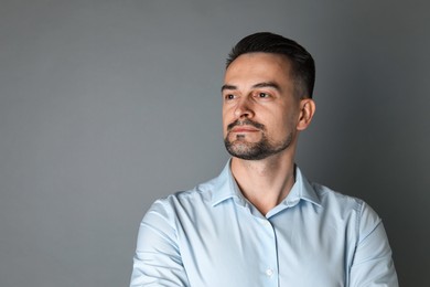 Photo of Portrait of handsome middle aged man on grey background, space for text