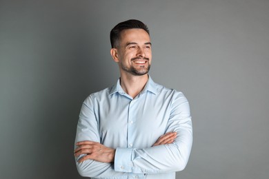 Photo of Portrait of handsome middle aged man on grey background