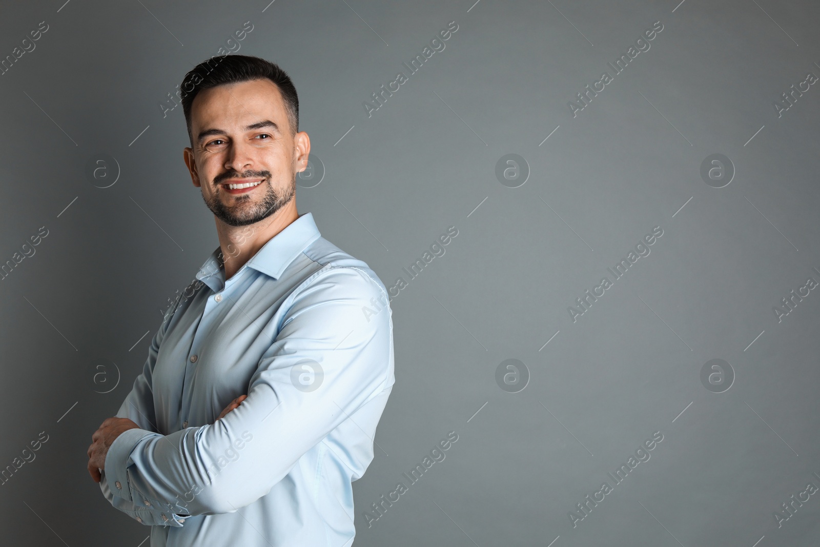 Photo of Portrait of handsome middle aged man on grey background, space for text