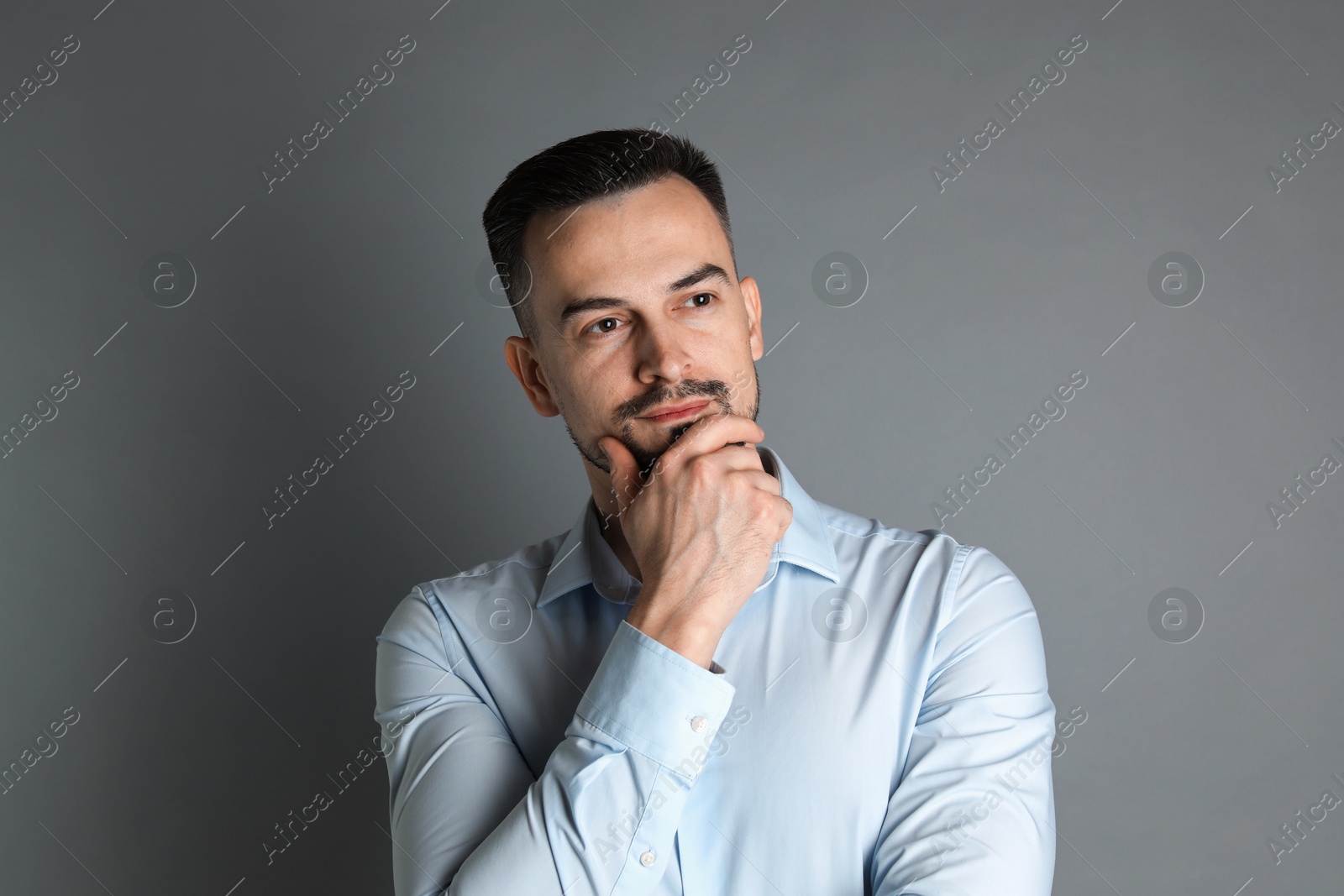 Photo of Portrait of handsome middle aged man on grey background