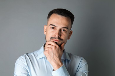 Photo of Portrait of handsome middle aged man on grey background