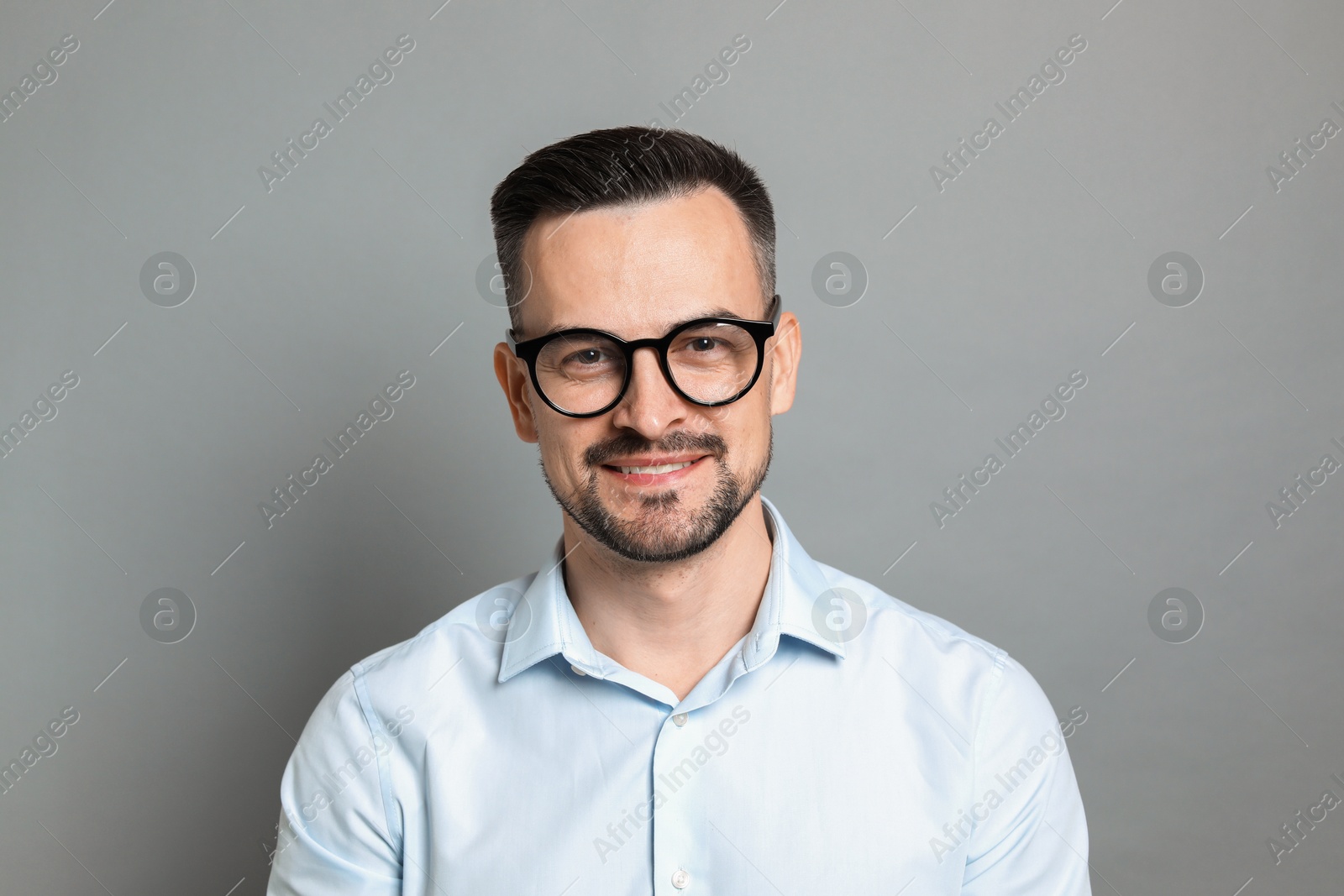 Photo of Portrait of handsome middle aged man on grey background