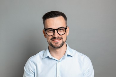 Photo of Portrait of handsome middle aged man on grey background