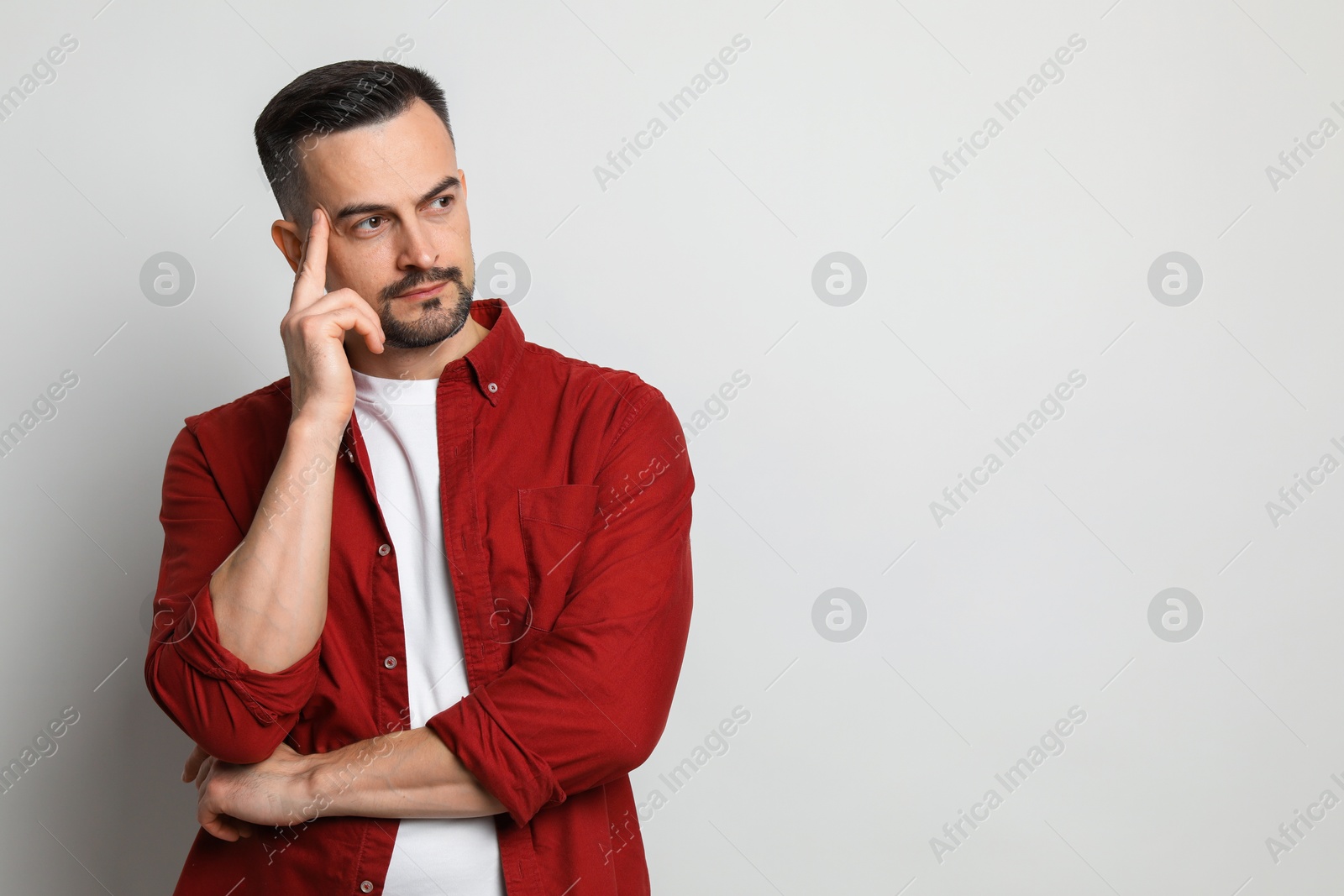 Photo of Portrait of handsome middle aged man on light background, space for text