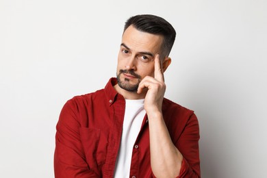 Portrait of handsome middle aged man on light background