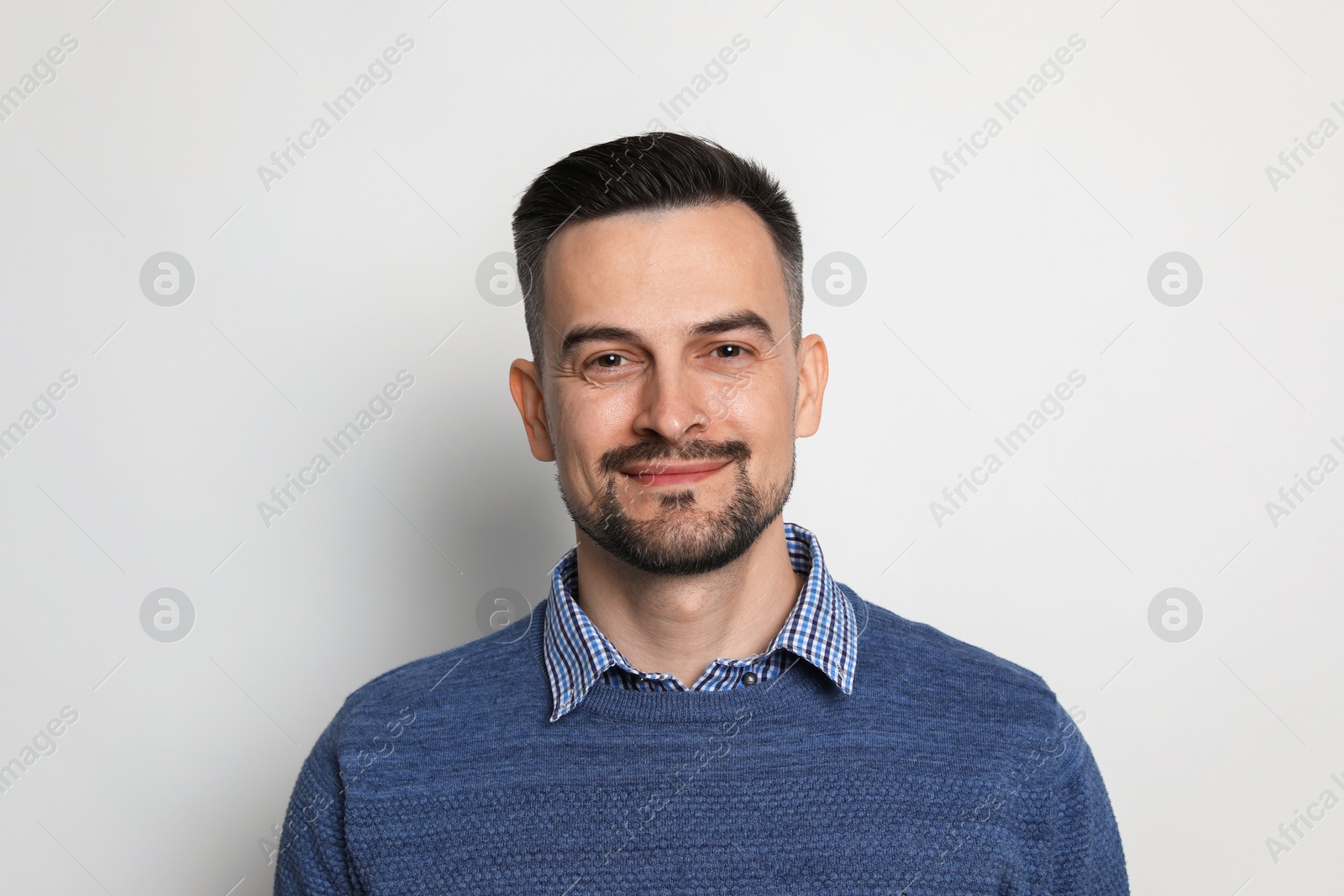 Photo of Portrait of handsome middle aged man on light background