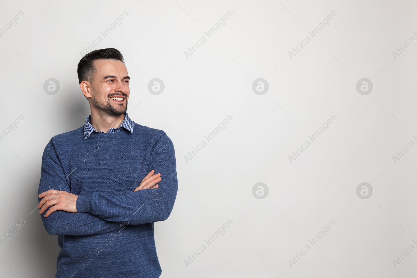 Photo of Portrait of handsome middle aged man on light background, space for text