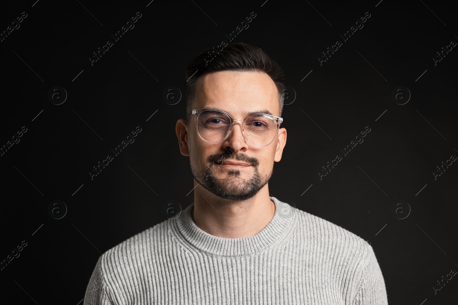 Photo of Portrait of handsome middle aged man on black background