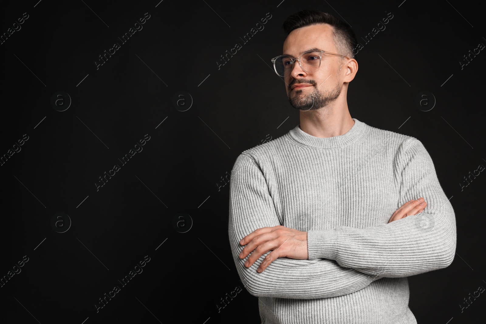 Photo of Portrait of handsome middle aged man on black background, space for text