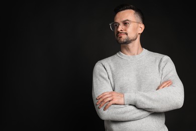 Photo of Portrait of handsome middle aged man on black background, space for text