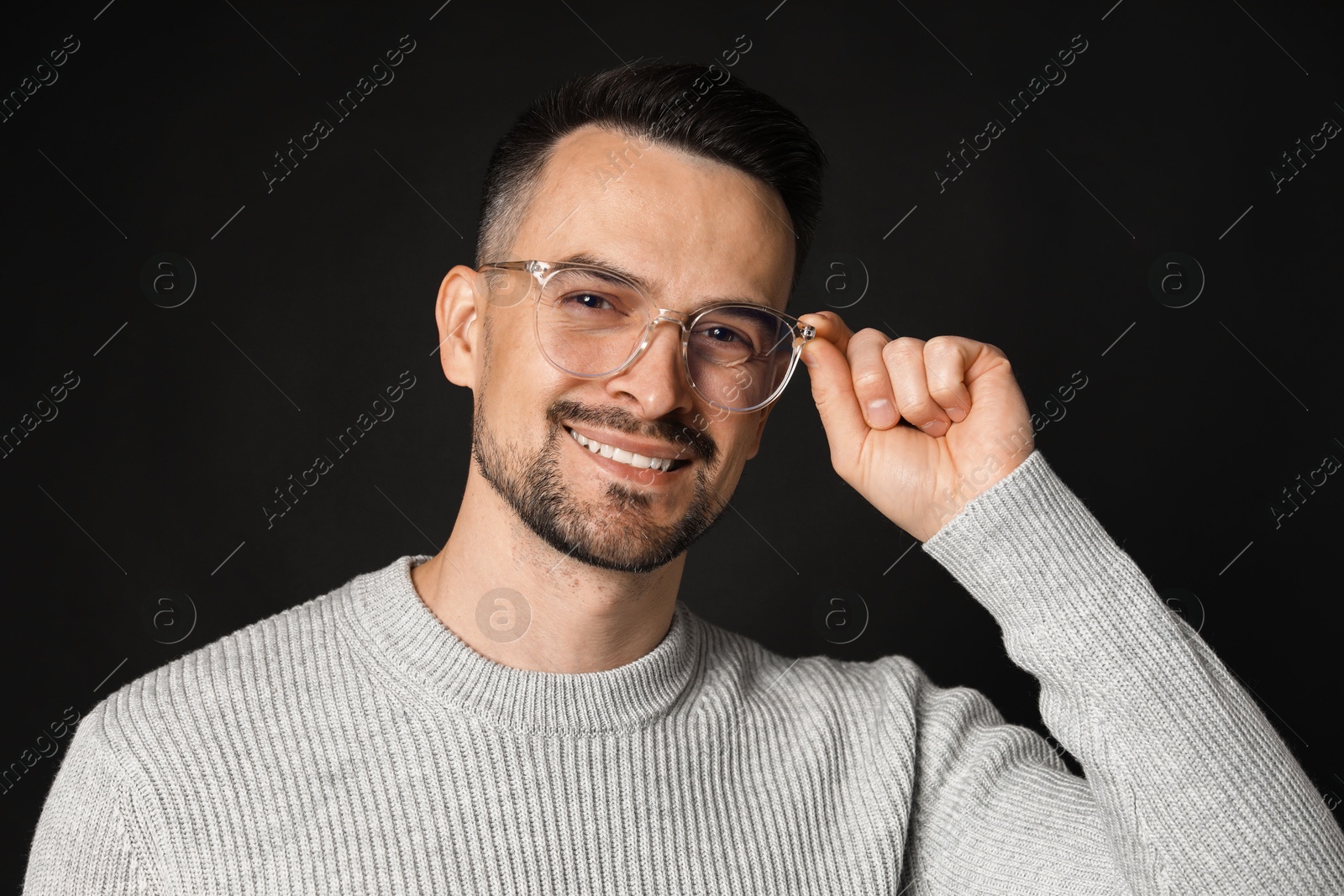 Photo of Portrait of handsome middle aged man on black background