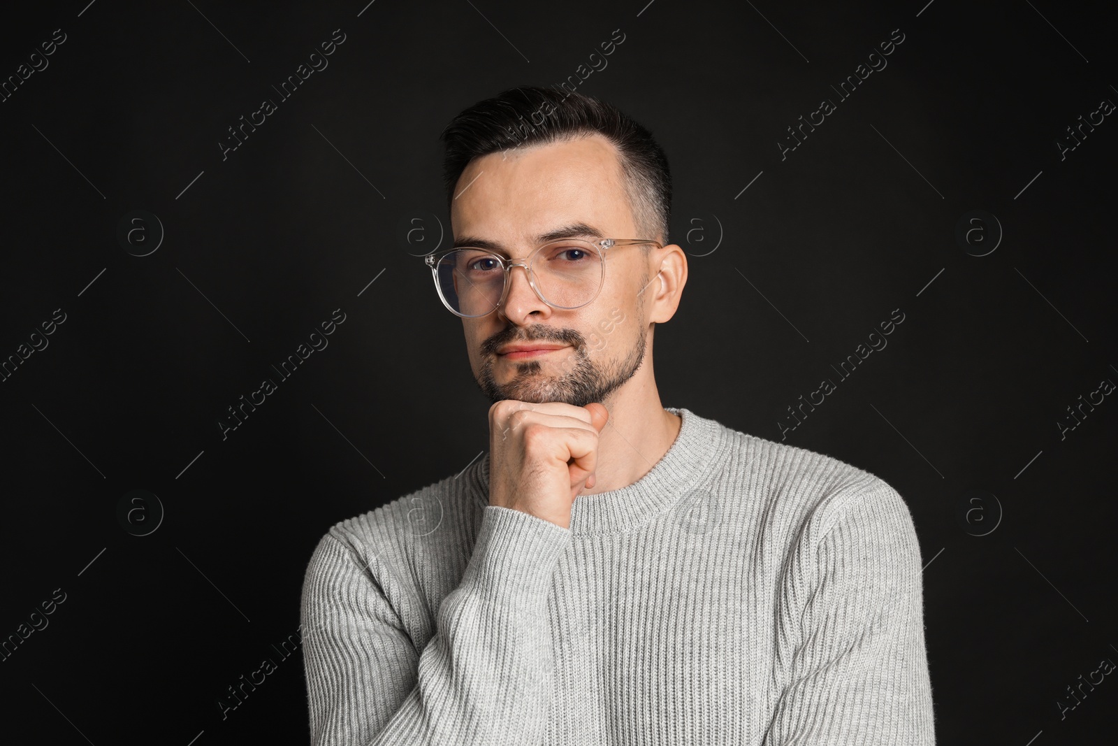 Photo of Portrait of handsome middle aged man on black background