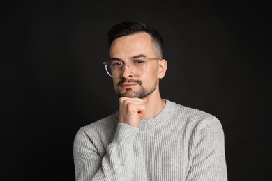 Photo of Portrait of handsome middle aged man on black background