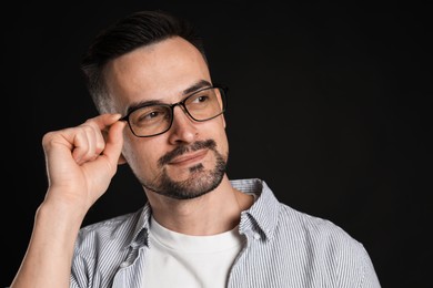 Photo of Portrait of handsome middle aged man on black background