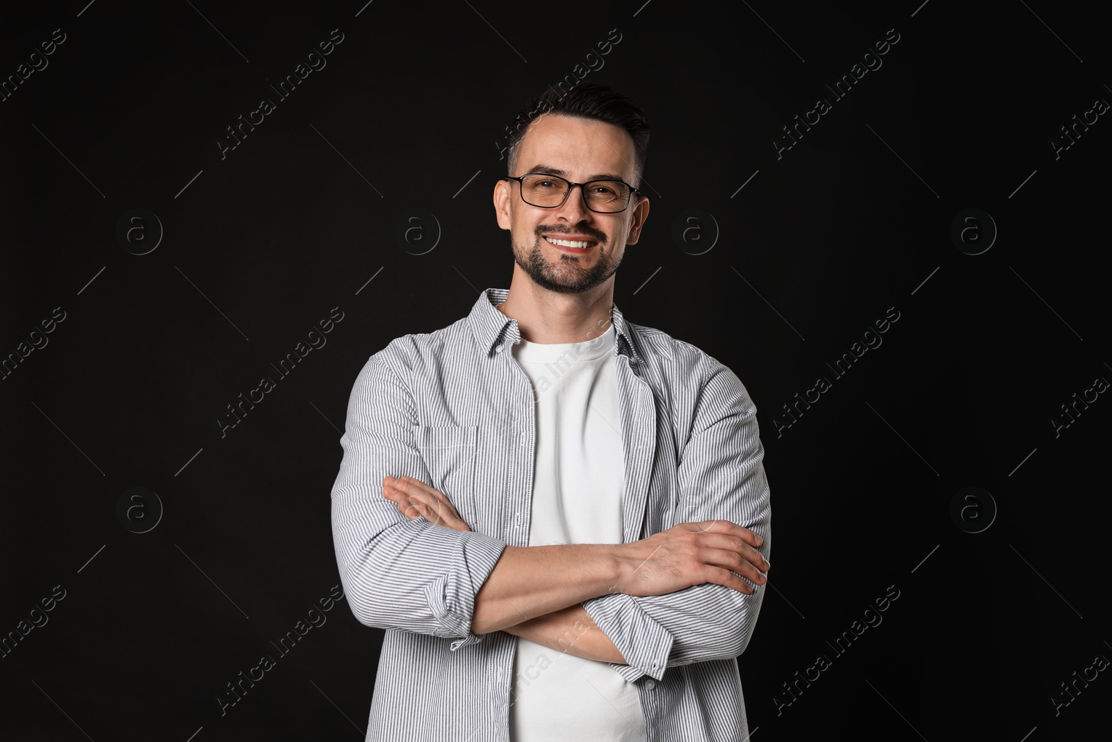 Photo of Portrait of handsome middle aged man on black background